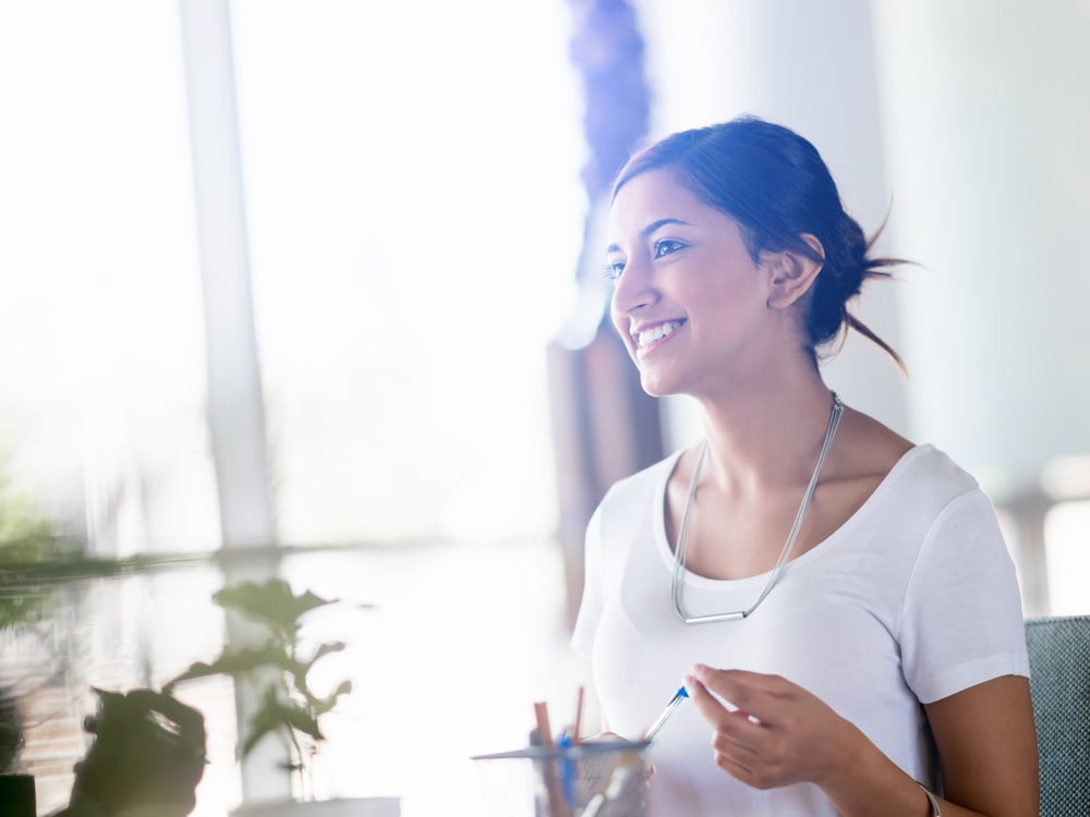 Young business woman talking to her collegue and smiling