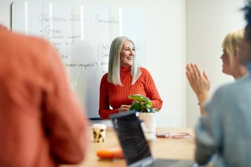 Woman smiling in front of colleagues