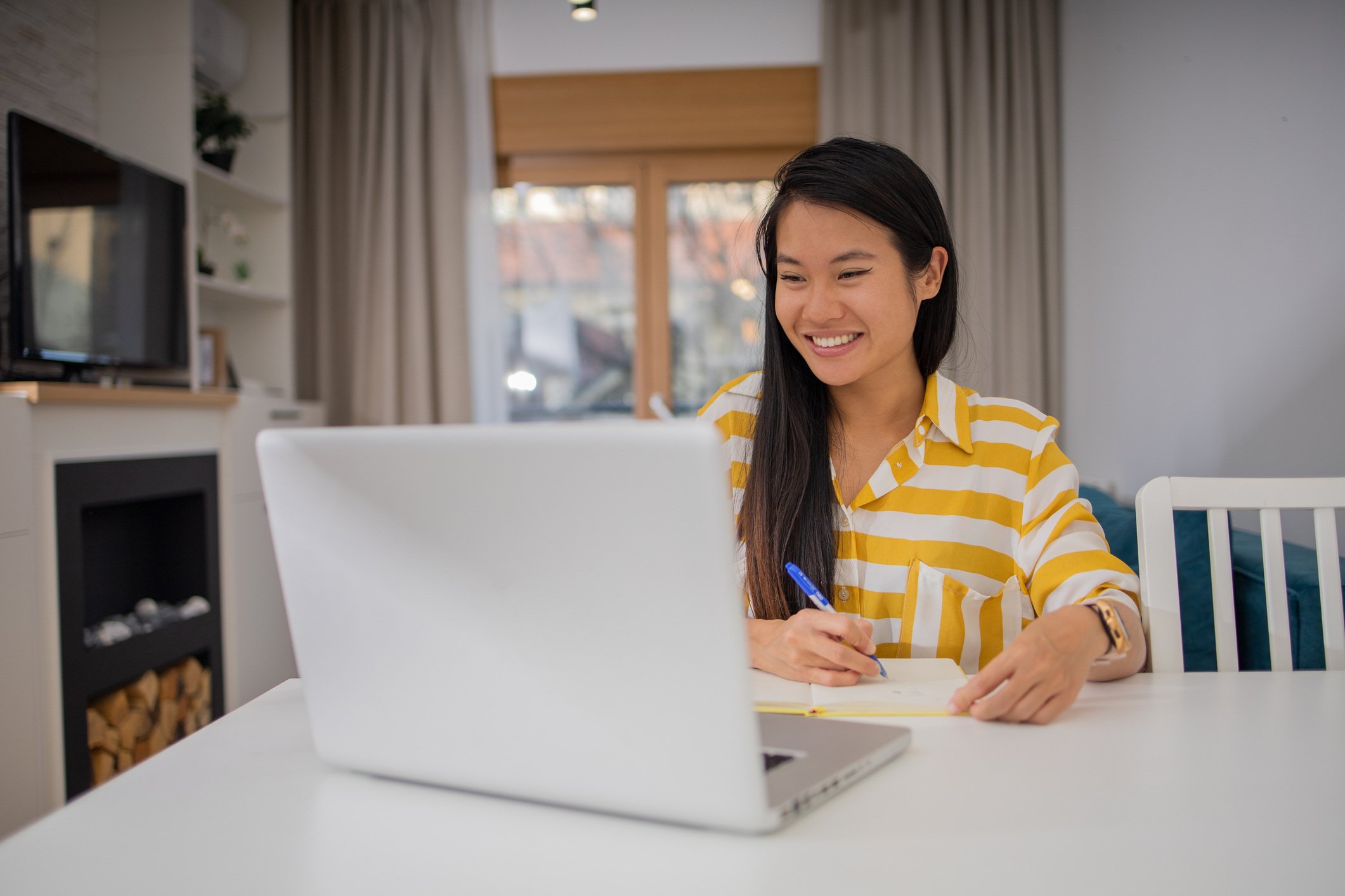 Request a Proposal woman smiling at computer