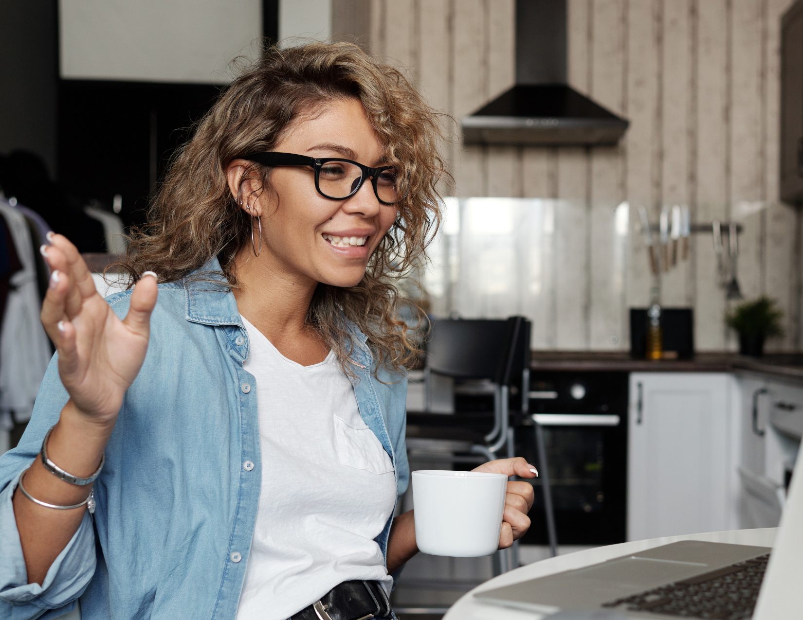 Woman with glasses talking on laptop video call